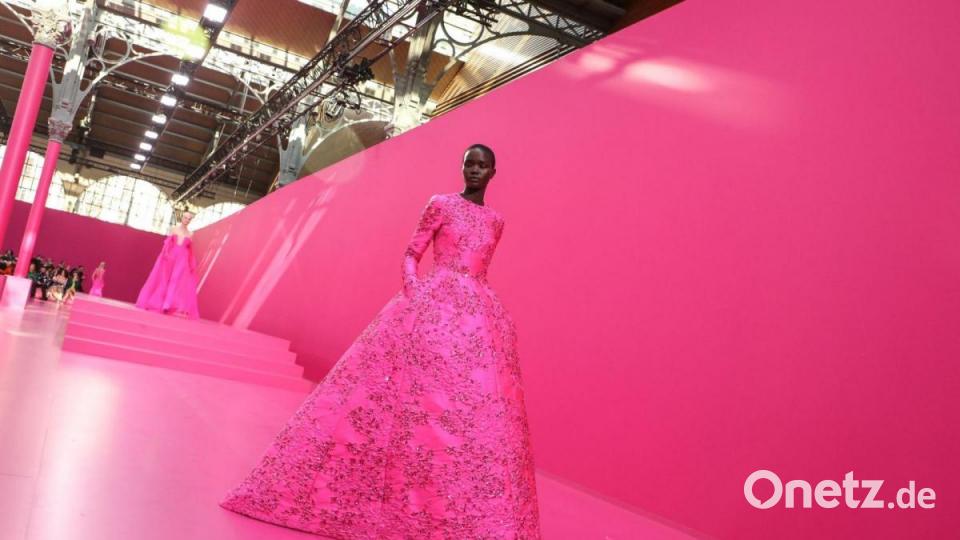 Während der Fashion Week in Paris präsentiert ein Model eine pinke Valentino-Kreation. Bild: Vianney Le Caer/Invision/dpa