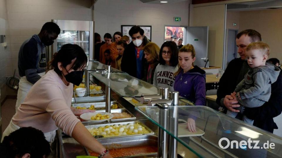 Ukrainische Kriegsflüchtlinge erhalten in der Kantine einer Jugendherberge im französischen Calais ein warmes Mittagessen. Bild: Michel Spingler/AP/dpa