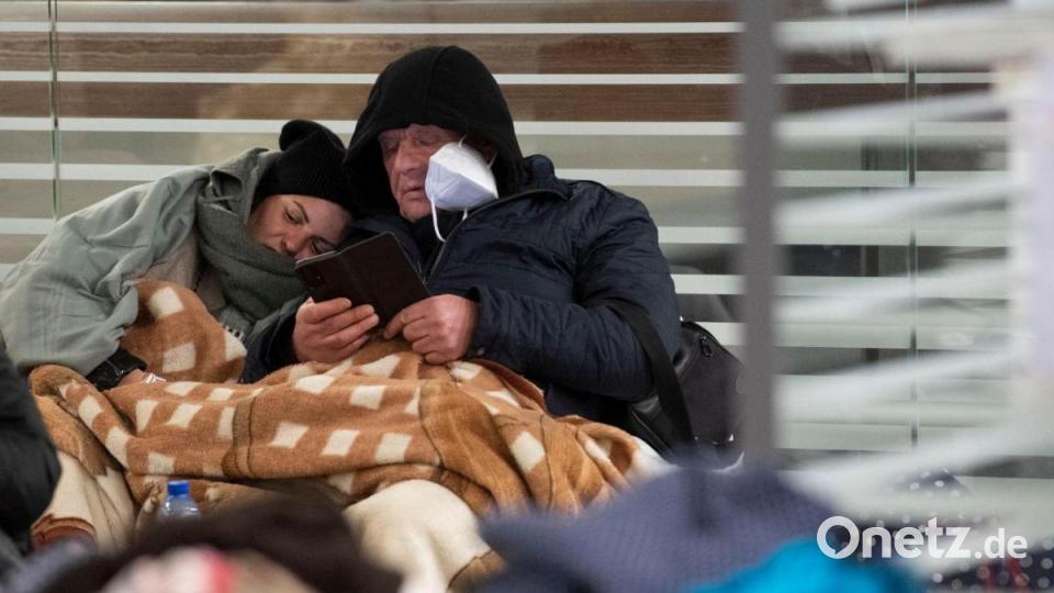Zwischen Reisetaschen sitzend warten aus der Ukraine geflüchtete Menschen am Sonntagmorgen am Berliner Hauptbahnhof auf ihre Weiterreise. Bild: Paul Zinken/dpa