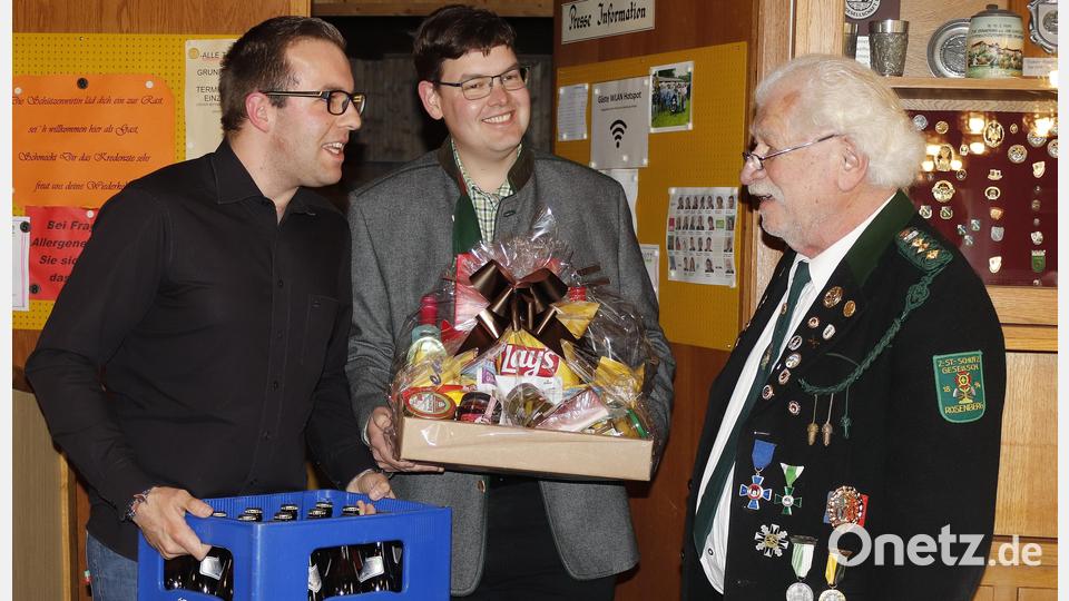 Der neu gewählte Schützenmeister Martin Partsch (links) und sein Stellvertreter Markus Rupprecht ernennen Reinhold Brandl zum Ehrenschützenmeister und besiegeln das mit einer Urkunde, einem Geschenkkorb und einem Kasten Bier. Bild: mfh