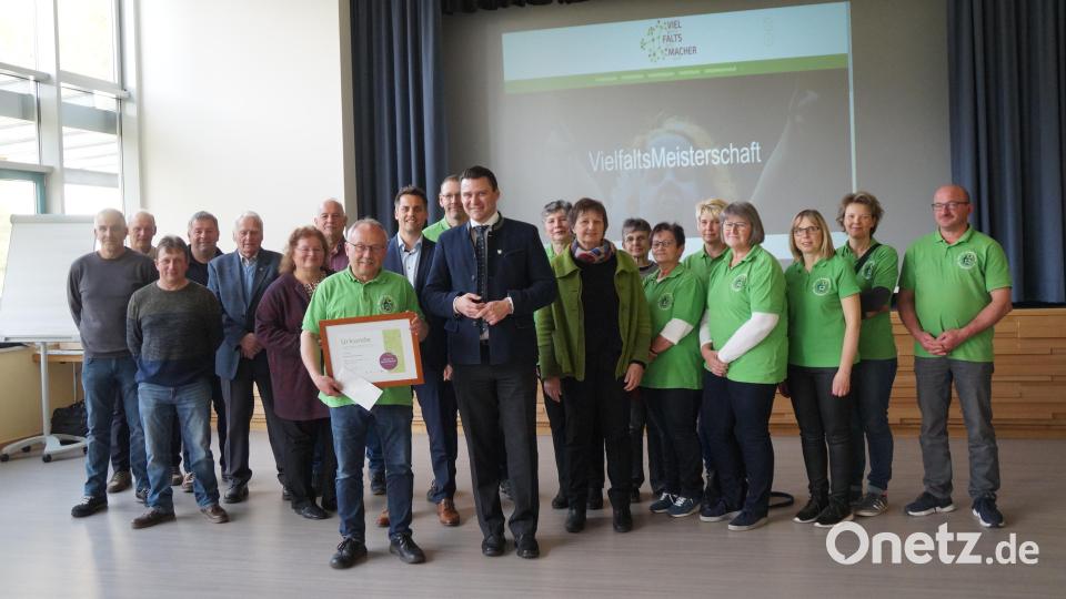 Vertreter des städtischen Bauhofs und Mitglieder des Obst- und Gartenbauvereins freuen sich mit Kreisfachberaterin Heidi Schmid (Sechste von links), Bürgermeister Rudolf Teplitzky (Neunter von links), Landrat Thomas Ebeling (Elfter von links) und Vorsitzendem Karl Ruhland über den ersten Preis der Vielfalts-Meisterschaft. Bild: wel