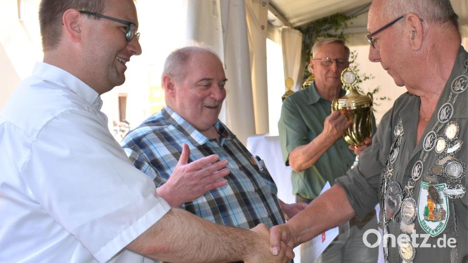 Schirmherr Pfarrer Daniel Fenk (links) und Stadtverbandsvorsitzender Gerhard Mark gratulieren dem neuen Fischerkönig Josef Biersack. Bild: rgr