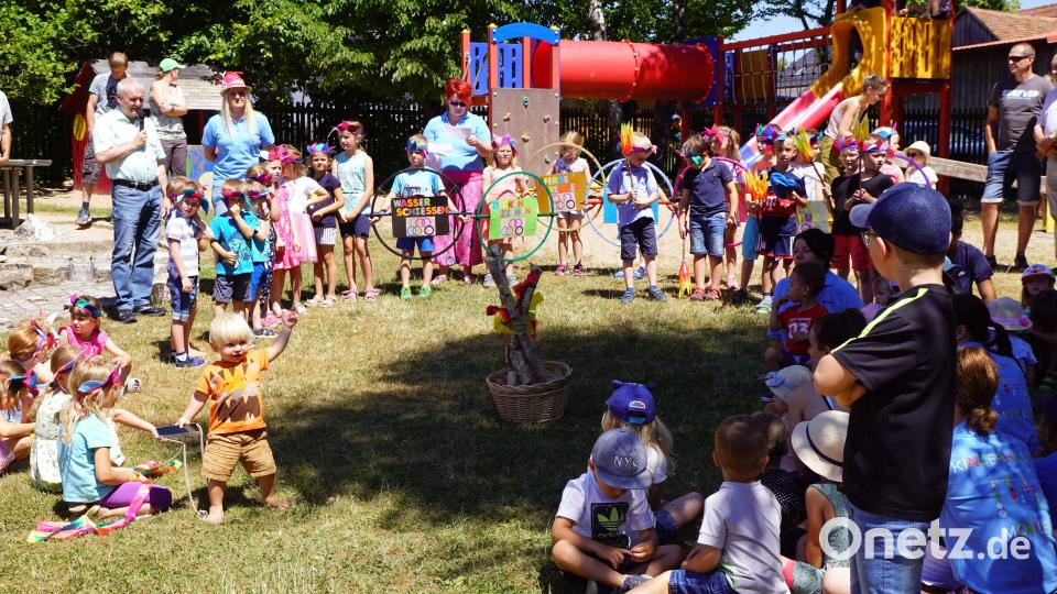 Bürgermeister Günter Kopp (links stehend) begrüßt alle, die zum Sommerfest gekommen waren, besonders die Kinder und Leiterin des Kindergartens Corinna Fröhler mit ihrem Team. Bild: bkr