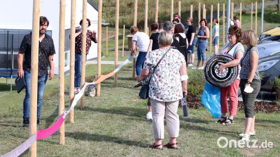Viele Helfer und Helferinnen befestigen den Schal. Bild: lst/exb