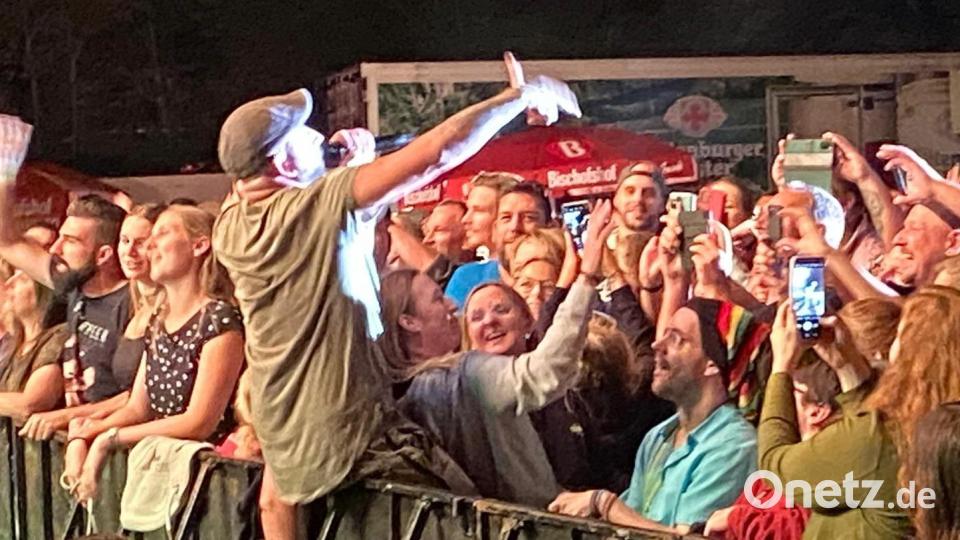 Christopher Seiler springt mittendrin runter von der Bühne und sucht den direkten Draht zu seinem Publikum, das ihn vorne an der Absperrung bejubelt. Bild: Wilhelm Amann