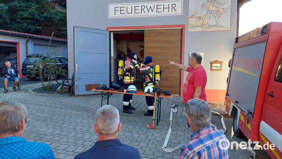 Erster Kommandant Benjamin Weiß (Mitte / links / rechts bzw. rotes Shirt 😊) erklärt die Technik und das korrekte Anlegen der Atemschutzgeräte. Zusätzlich im Bild (unter PA) von links Zweiter Kommandant Dennis Schubert und Johannes Winkler. Bild: Michael Weiß