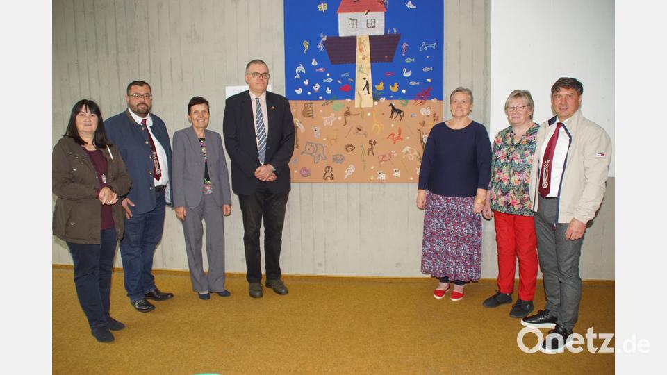 Grußwortredner stellvertretende Landrätin Birgit Höcherl (links) und Alexander Dietz (Euregio Egrensis/Vierter von links), mit (von rechts) VG-Vorsitzenden Gerald Reiter, Klöppelkreis-Sprecherin Frieda Roith, Fachexpertin Mirka Vacková, Dolmetscherin Mrika Sebestova und Rektor Thomas Troidl vor dem Arche-Noah-Bild mit den geklöppelten Motiven. Bild: mmj