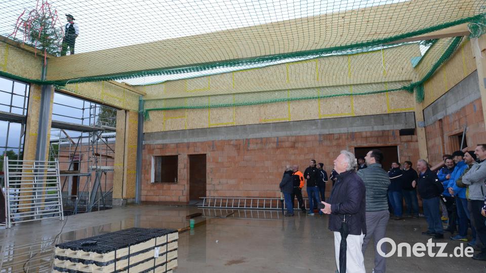 Architekt Josef Schöberl, Bürgermeister Sebastian Hartl (von links) und die weiteren geladenen Gäste lauschen Zimmermeister Michael Kohl bei seinem Richtfestspruch zu. Bild: bey