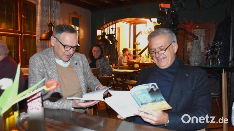 Bürgermeister Bernd Sommer von Waldsassen (links) und Landrat Roland Grillmeier durften ausnahmsweise noch vor der offiziellen Vorstellung ins neue Buch schauen. Bild: ubb