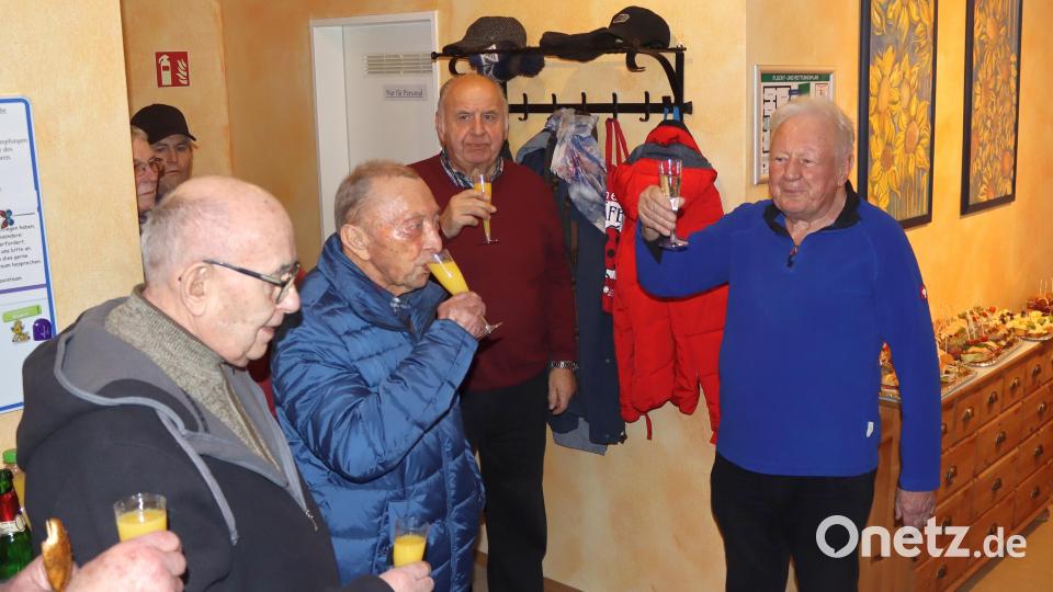 Dr. Volkmar Kretz (rechts) hebt zusammen mit Freunden und Patienten das Glas zum 50-jährigen Praxisjubiläum. Bild: mfh