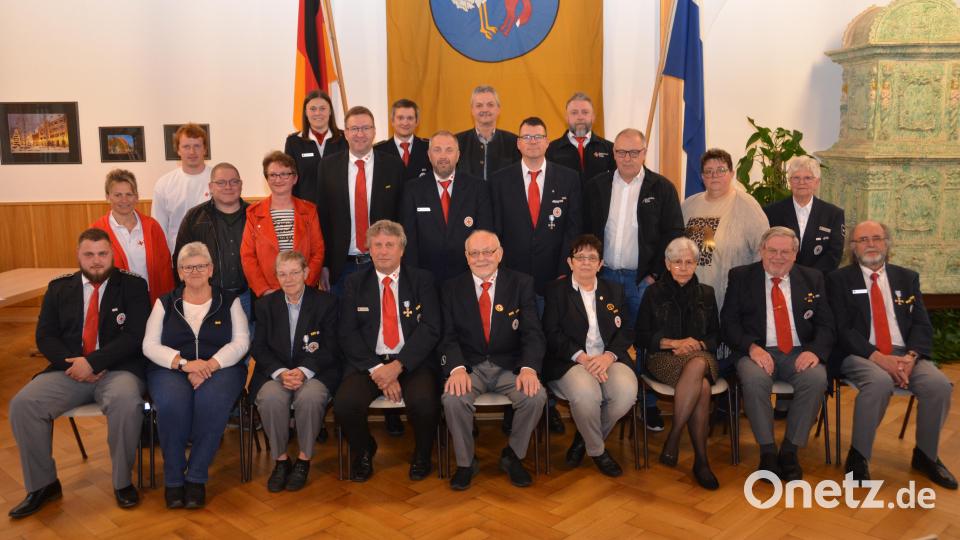 Willi Helgert (sitzend, Mitte) ist der Spitzenreiter unter den Geehrten. Seit 60 Jahren leistet er Dienst für das BRK. Dafür erhielt er nicht nur die goldene Auszeichnungsspange der Bereitschaft, sondern auch die Ehrennadel des Deutschen Roten Kreuzes. Bürgermeister Andreas Wutzlhofer (hinten, Mitte) nennt die Geehrten die Säulen der BRK-Bereitschaft. Bild: dob