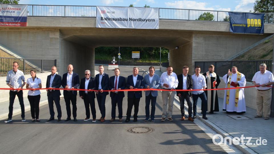 Diplomingenieur Johannes Fürst, DB-Abteilungsleiter Daniel Cifrain (Dritter und Vierter von links), Landrat Florian Wiedemann, Bürgermeister Christian Porsch und Staatsminister Christian Bernreiter (Sechster bis Achter von links) durchschnitten mit weiteren Ehrengästen das rote Band zur Verkehrsfreigabe. Bild: ak