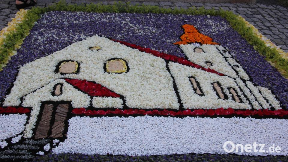 Einen wunderschönen Blumenteppich mit dem Abbild der Pfarrkirche St. Michael hatte das Landvolk Schwarzenbach vor dem Eingang in die Kirche aufgebaut. Bild: kro