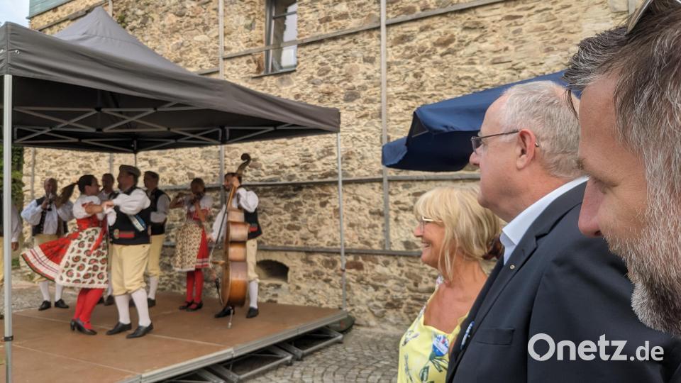 Irene Träxler, Lothar Höher und Rudolf Špoták, die Repräsentanten von Bavaria Bohemia e.V., Bezirkstag Oberpfalz und Region Pilsen freuen sich beim Sommerempfang über die Musik- und Tanzgruppe „Chodský soubor Mrákov“ (Chodensemble Mrákov) aus dem Chodenland. Bild: eib