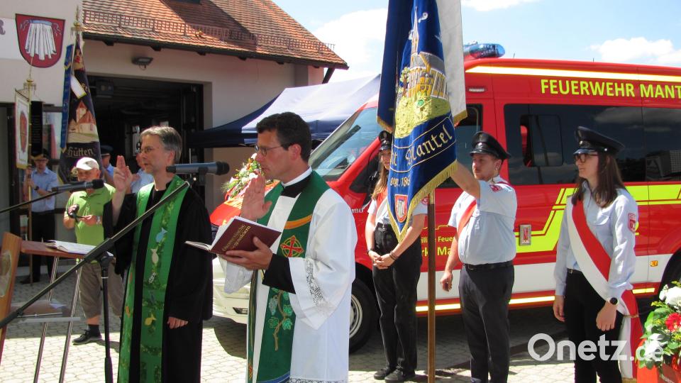 Pfarrer Thomas Kohlhepp (rechts) und Pfarrer Andreas Ruhs (links) erteilen dem neuen Fahrzeug und der Tragkraftspritze den kirchlichen Segen. Bild: sei