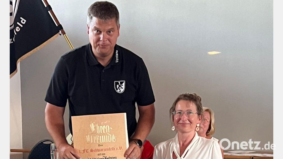 Den 1. FC Schwarzenfeld gibt es seit 100 Jahren. Bianca Härtl überreicht die Glückwünsche an Christian Liebl. Bild: Silvia Beck/exb