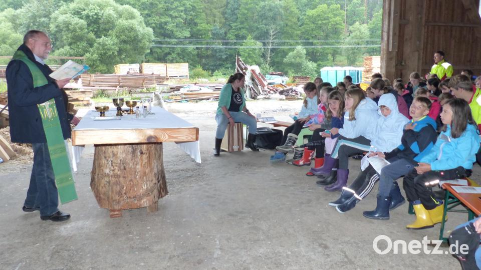 Pfarrer Alfons Forster feiert mit den Ministranten, Lagerleitern und Gemeindereferentin (an der Trommel) sowie dem Hofhund Gottesdienst in der Scheune. Bild: sl