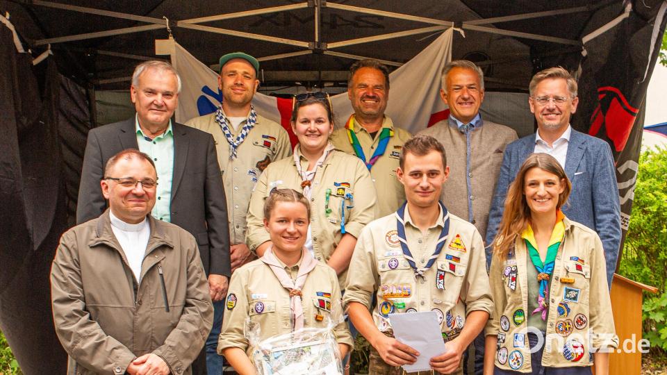 Verabschiedet wurde Bezirkskurat Johannes Birkner (hinten, Zweiter von links). Mit im Bild sind (von links): Pfarrer Markus Bruckner, Bürgermeister Günter Kopp, Bezirksvorstand Michael Brunner, Stammesvorsitzende Romy Christl, Bezirksvorständin Julia Helgert, Stamesvorsitzender Felix Linkel, Landrat Roland Grillmeier,Diözesanvorständin Eva-Maria Linkel und MdL Tobias Reiß. Bild: Markus Koenig/exb