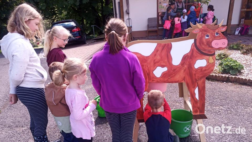 An der Melkstation mit einer selbstgebastelten Holzkuh gab es einen kleinen Wettbewerb für die Kinder. Wer hatte in 30 Sekunden das meiste Wasser im Eimer? Bild: CSU Pechbrunn/exb