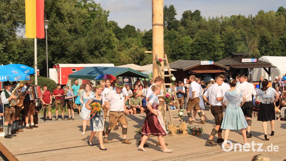 Das Baumaustanzen ist der Höhepunkt der Riedener Kirwa, bei dem als neues Oberkirwapaar Elena Haas und Sebastian Schmidt (mit Kopfbedeckung) ermittelt werden. Die Schnarrndorfer Musikanten (links) geben den Takt vor. Bild: mrr