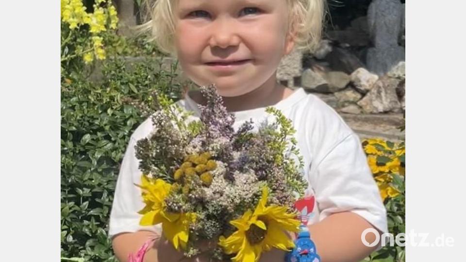 Ein kleines Mädchen trägt die selbstgepflückten Blumen nach Hause zum Trocknen lassen, als Segen für Haus und Hof. Bild: gis