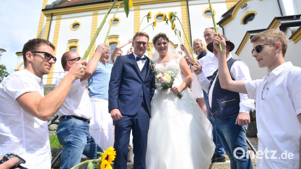Steckenpferde und Sonnenblumen – das frisch getraute Paar Mario und Stefanie Riedel ging freudestrahlend durch das bunte Spalier. Bild: bey