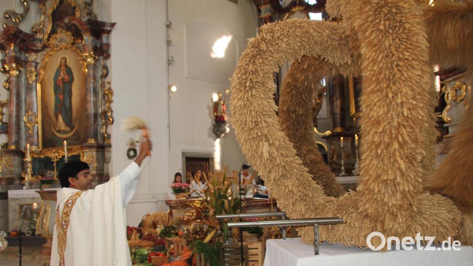 Nach dem Gottesdienst segnet Kaplan Chinna Chennaiah Dola die von der Dorfgemeinschaft Eigelsberg/Niesaß vor dem Altar platzierten Feldfrüchte. Rechts im Bild die vom Obst- und Gartenbauverein Oberviechtach gefertigte Erntekrone. Bild: frd