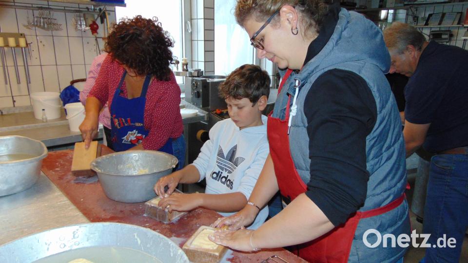 Die Buttermasse in Form zu bringen ist anstrengend macht aber auch Spaß. Auch der Nachwuchs hilft erstmals mit Bild: fnk