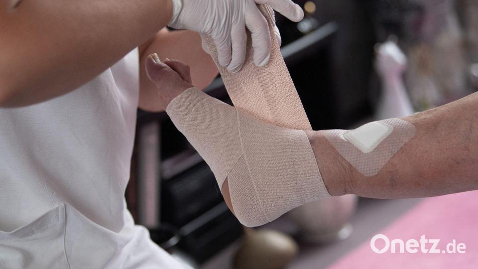 Eine Pflegefachkraft legt in der ambulanten Pflege einen Kompressionsverband an. Bild: Sebastian Gollnow/dpa/Symbolbild