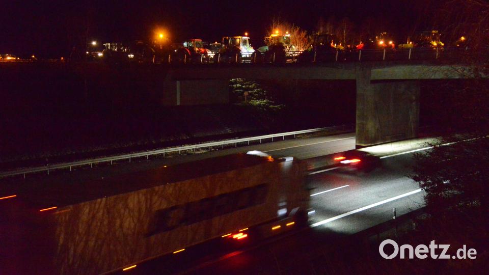 Auf Bitte von Polizeihauptkommissar Tobias Wirth waren die schweren Traktoren aus statischen Gründen von der Brücke über die BAB A 6 heruntergefahren und auf einer landwirtschaftlichen Fläche abgestellt worden. Bild: bey