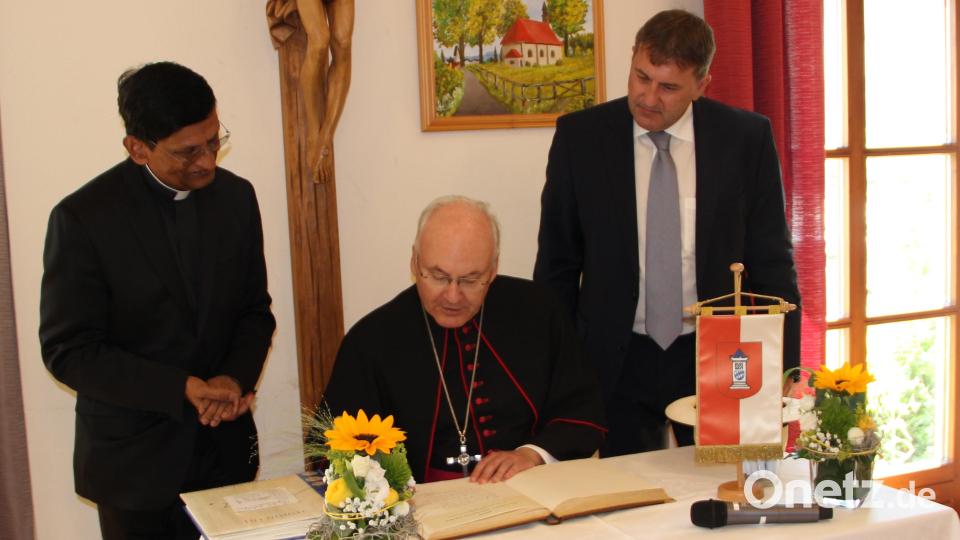 Bischof Rudolf Voderholzer trug sich in das Goldene Buch der Marktgemeinde Kirchenthumbach ein. Links Pfarrer Augustin Lobo, rechts 2. Bürgermeister Ewald Plößner. Bild: lep