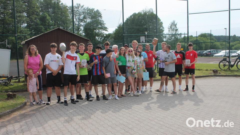 Nach der regenbedingten Verschiebung freuen sich die Spielvereinigung Trabitz und Bürgermeisterin Carmen Pepiuk (links neben dem Siegerteam &quot;Inter Highland&quot;) über ein fair verlaufenes Gaudi-Elfmeterturnier. Bild: bjp