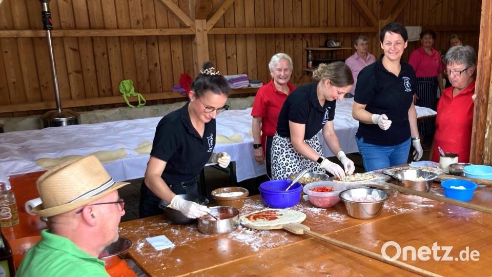 Teamwork war erforderlich, um Pizzen und Zwiebelkuchen für den Backofen vorzubereiten. Bild: no