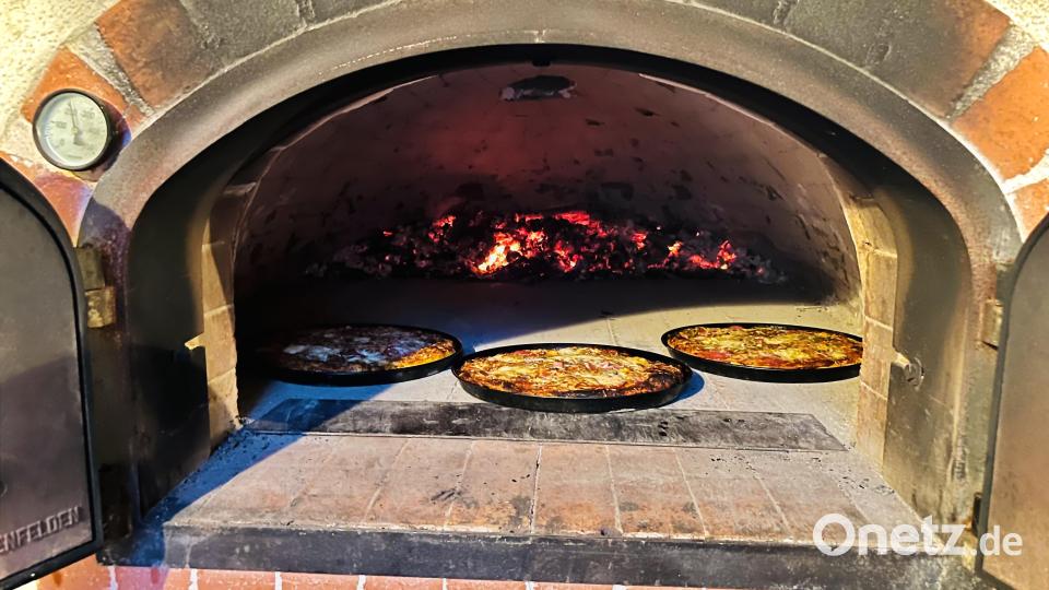 Die Glut im Backofen bringt jetzt für die Pizzen die richtige Temperatur. Bild: dob