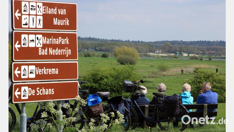 In der Betuwe gibt es ein dichtes Netz von Radrouten: Hier machen bei Eck en Wiel nahe Buren Radreisende Pause am Nederrijn (Niederrhein). Bild: Bernd F. Meier/dpa