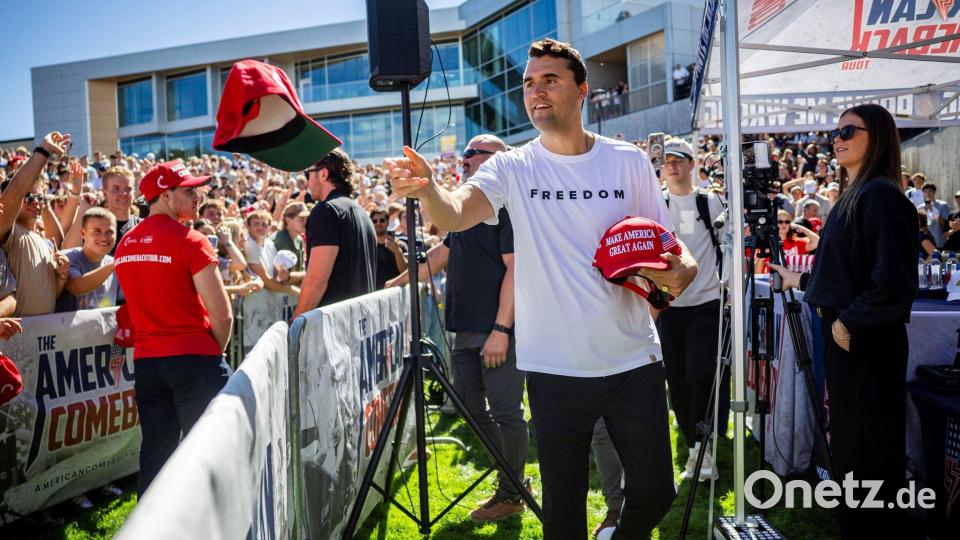 Charlie Kirk verteilt vor seiner Rede an der Utah Valley University Mützen. Kirk wurde bei der Veranstaltung erschossen. Bild: Tess Crowley/The Deseret News/AP/dpa