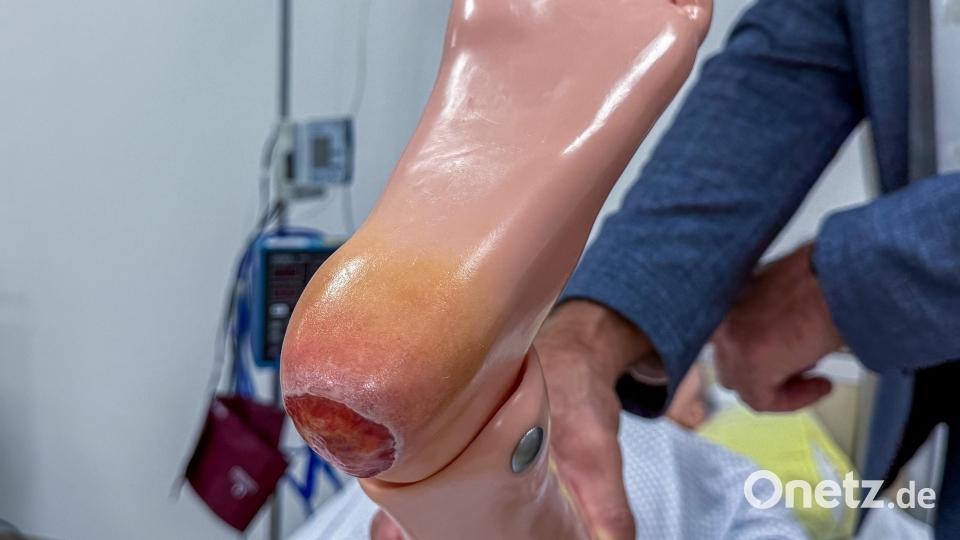 Anhand ziemlich realistischer Wunden – hier ein Dekubitus (offene Wunde) – an der Pflegepuppe können die Schüler den Umgang damit erlernen. Bild: Stephan Huber