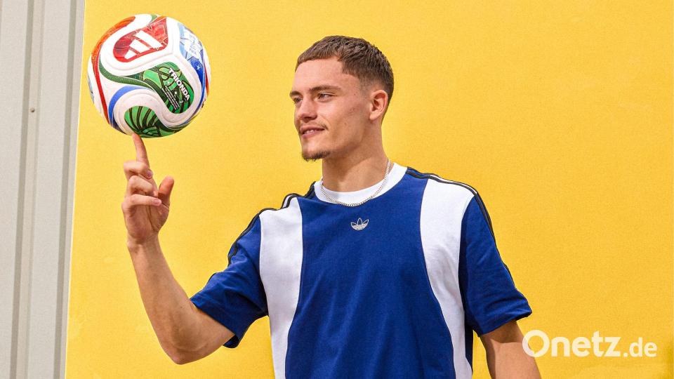 Florian Wirtz mit dem offiziellen WM-Spielball „Trionda“. Bild: ---/Adidas/dpa