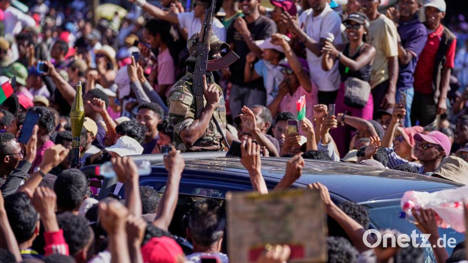 Demonstranten bejubeln Angehörige des Militärs auf Madagaskar, als diese den Sturz des Präsidenten ankündigen. Bild: Brian Inganga/AP/dpa