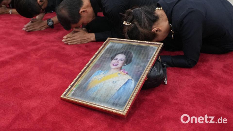 Trauernde beten in Bangkok mit einem Porträt der Königinmutter Sirikit. Bild: Sakchai Lalit/AP/dpa