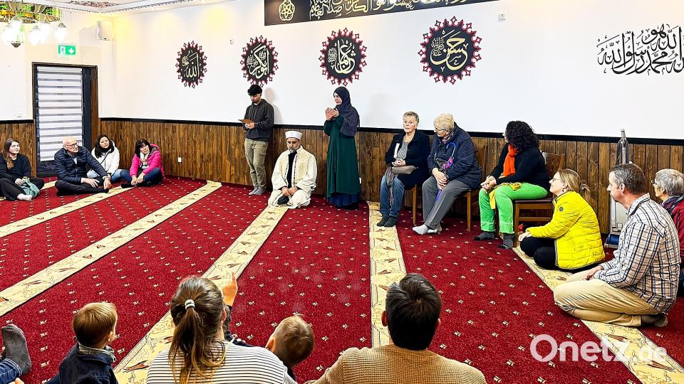 Im Nebenraum stellte sich der Imam (Mitte) den Fragen der Gäste - von der jungen Frau rechts neben ihm wurden die Fragen und Antworten geschickt vom Deutschen ins Arabische und zurück gedolmetscht. Bild: Peter Ringeisen