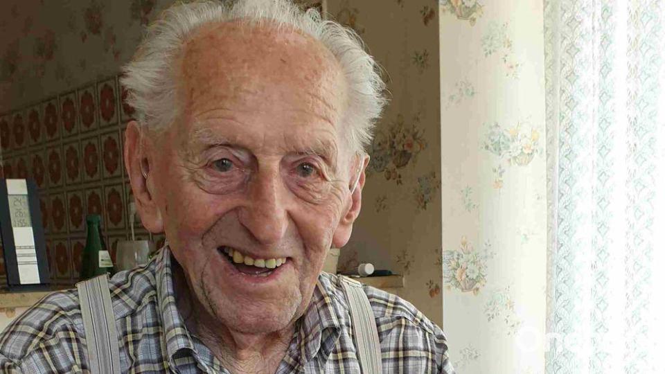 Karl Haidle sitzt an seinem 104. Geburtstag an einem Tisch und liest Zeitung. Bild: Sebastian Striebich/ZVW/dpa