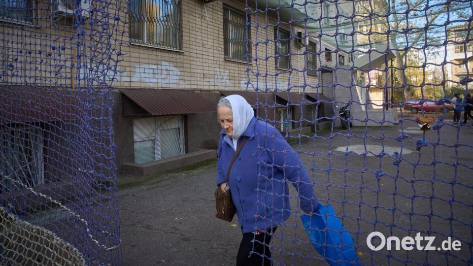 Eine Anwohnerin geht durch einem mit einem Anti-FPV-Drohnennetz bedeckten Hof in der Frontstadt Cherson in der Südukraine. Bild: Efrem Lukatsky/AP/dpa