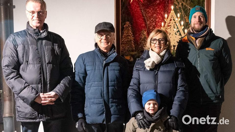 Bürgermeister Hermann Falk (links) öffnete am Montag das erste Türchen des 23. Lebendigen Adventskalenders. Er dankte allen, die zum Gelingen der Veranstaltungsreihe beitragen. Dies taten auch der Gewerbeverbandsvorsitzende Alfred Härtl (Zweiter von links) und der Trachtenvereinsvorsitzende Michael Meier (rechts). Petra Waldhauser (2. von rechts mit Enkel Leo), die Vorsitzende der Selbsthilfegruppe krebskranker Kinder, dankte dafür, dass ihr Verein heuer als Spendenempfänger ausgewählt wurde. Bild: u