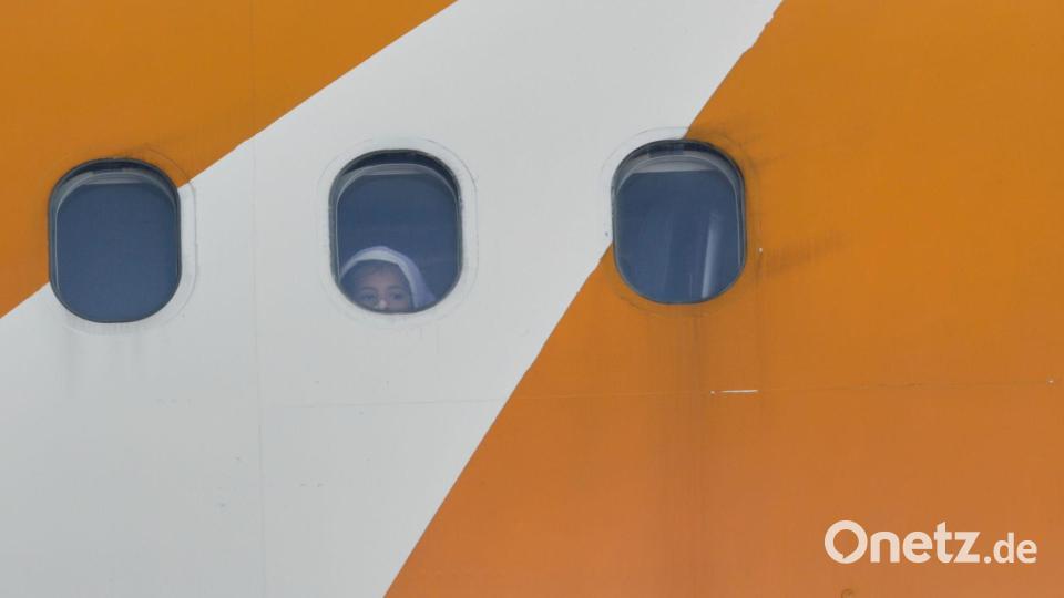 Ein Kind blickt aus einem von Venezuela betriebenen Flugzeug, das mit abgeschobenen Migranten aus den USA auf dem Flughafen Simon Bolivar International in Maiquetia ankommt. Bild: Cristian Hernandez/AP/dpa