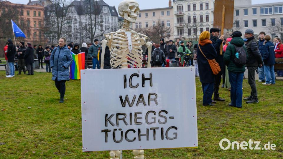 Bis auf die Knochen: Mit einem Skelett wird in Cottbus gegen eine mögliche Wehrpflicht demonstriert. Bild: Patrick Pleul/dpa