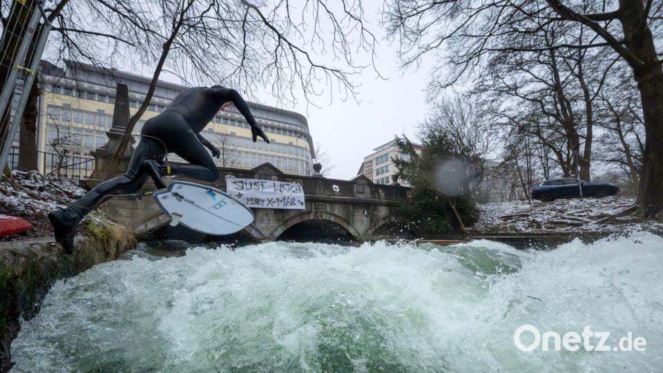 Ein Weihnachtswunder? Auf dem Eisbach wird wieder gesurft. Bild: Peter Kneffel/dpa