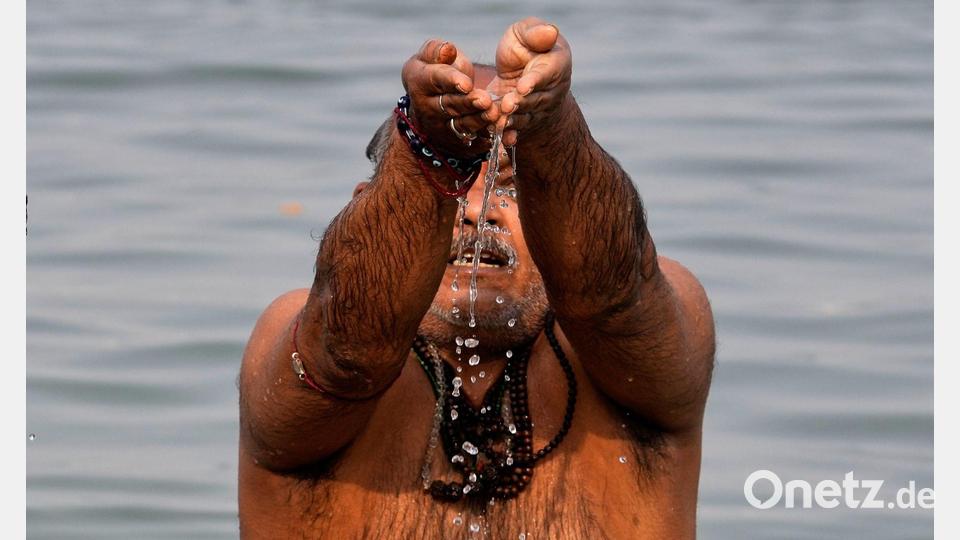 Ein Hindu-Pilger verehrt den Sonnengott während eines rituellen Bades im Hooghly-Fluss anlässlich des Makar Sankranti-Festes in Kolkata. Bild: Bikas Das/AP/dpa