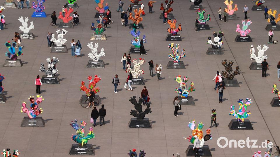 Menschen betrachten monumentalen Skulpturen in Form von Kakteen die von mexikanischen Künstlern gefertigt wurden. Bild: Carlos Santiago/eyepix via ZUMA Press Wire/dpa