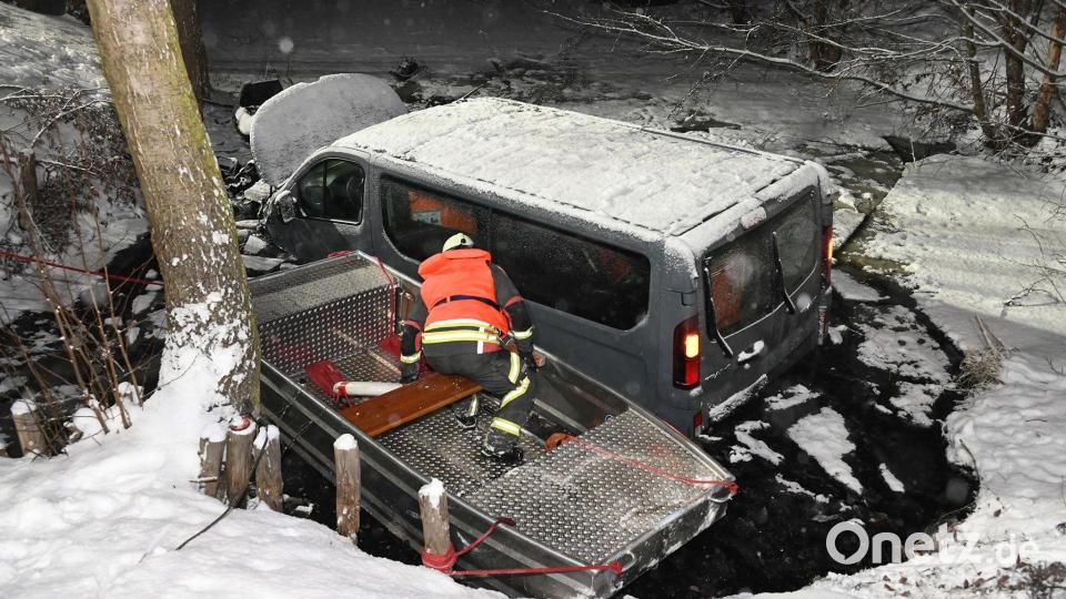 Ein Feuerwehrmann in einem Rettungsboot inspiziert einen Transporter in einem Löschteich. Bild: Dietmar Thomas/EHL Media/dpa